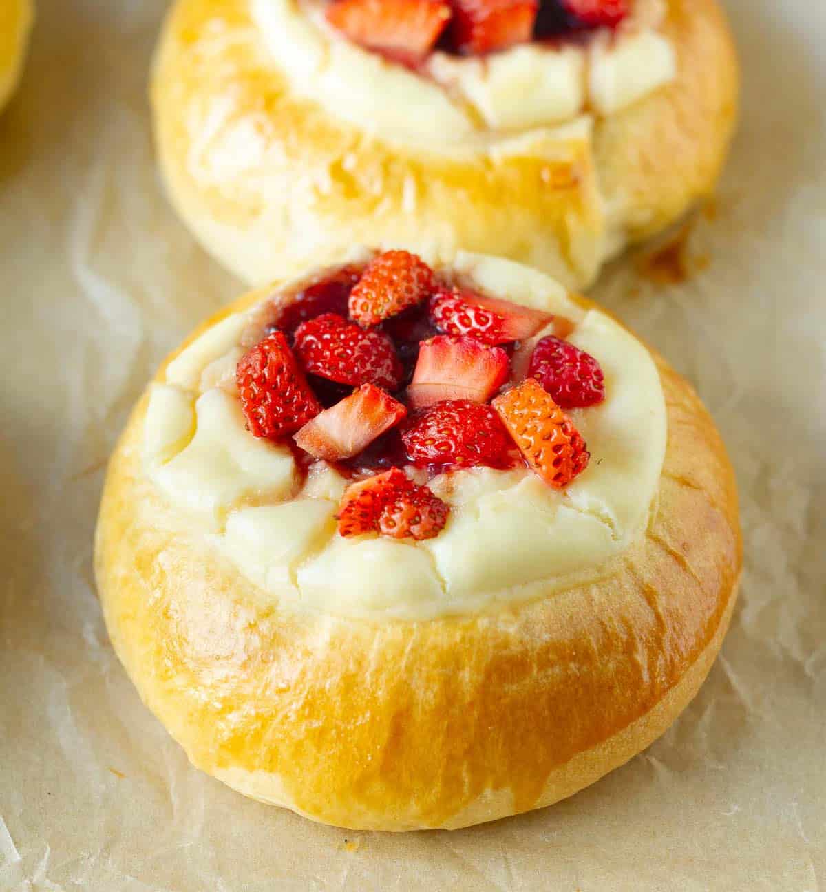 Strawberry cheesecake bun topped with fresh strawberries.