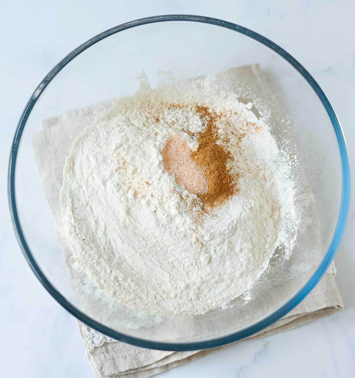 Dry ingredients in a glass mixing bowl.