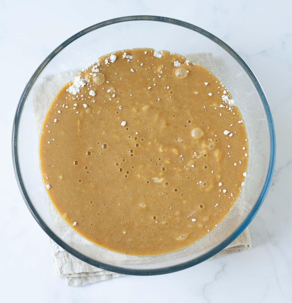 Dry and wet ingredients in a mixing bowl to make a batter.