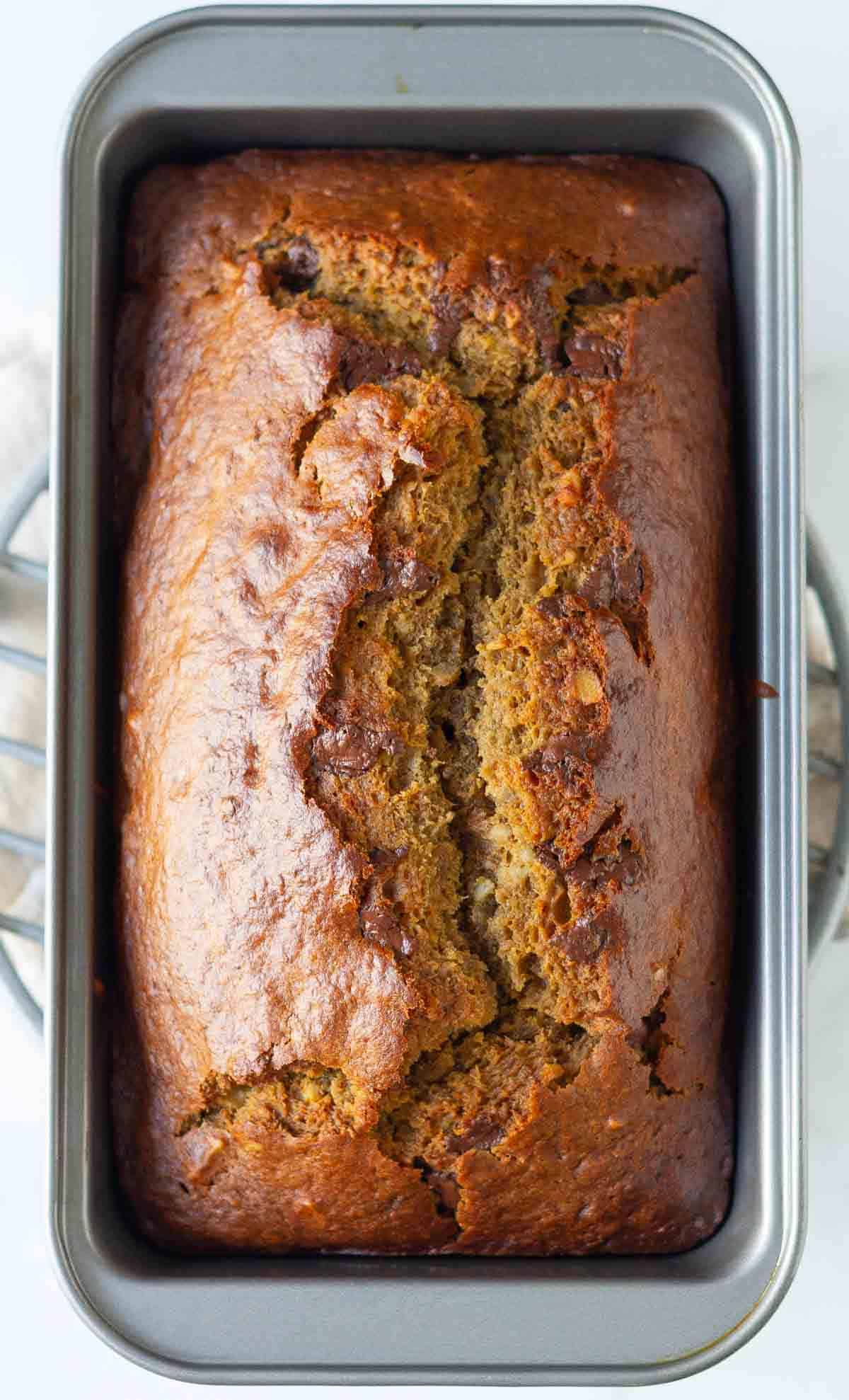 Baked sourdough banana bread in a loaf pan.