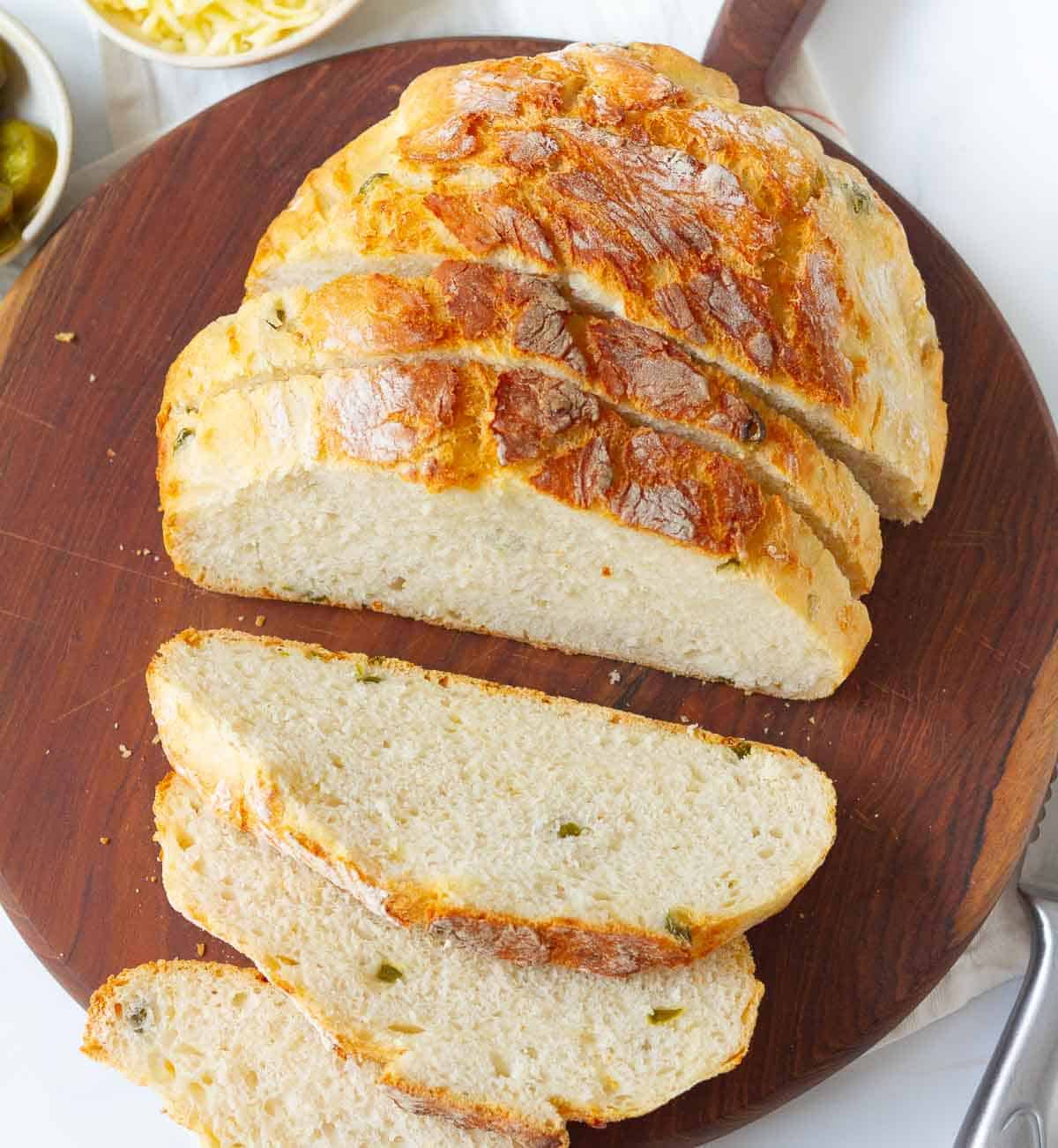 Sliced loaf of bread on a wooden board.