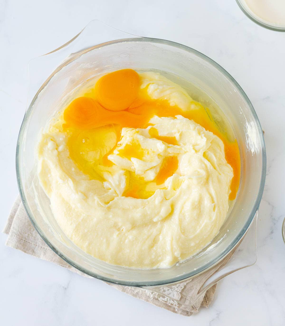 eggs on cream cheese mixture in a mixing bowl.