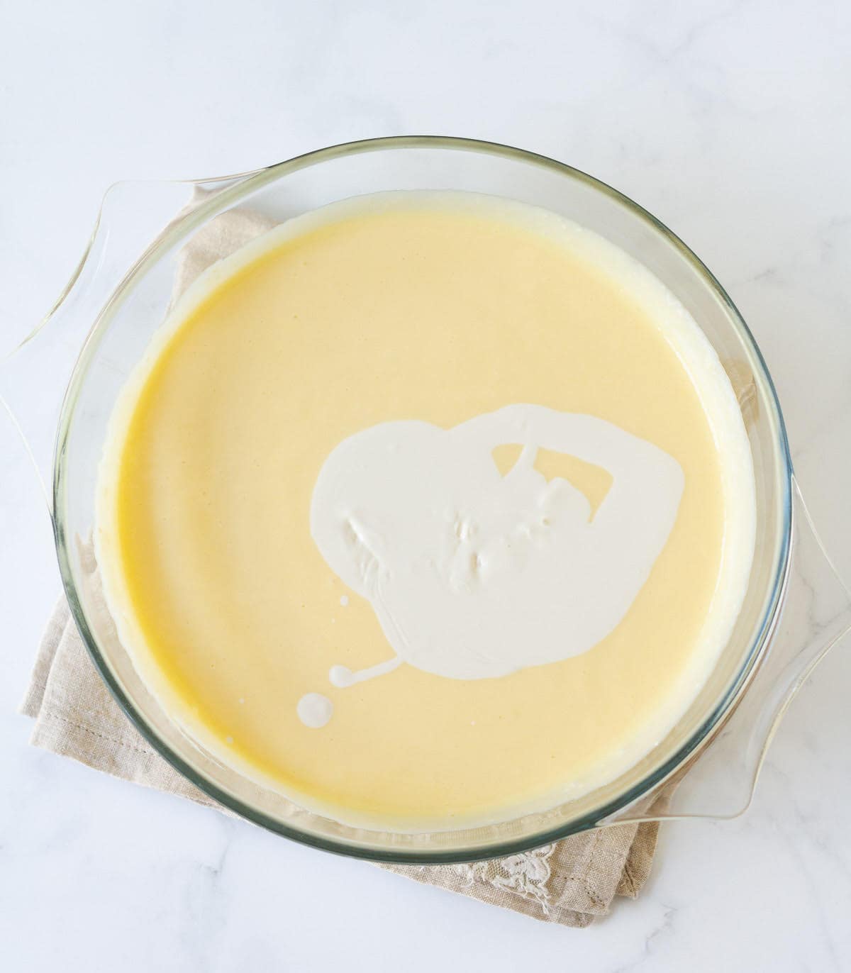 Cream on cream cheese mixture in a mixing bowl.