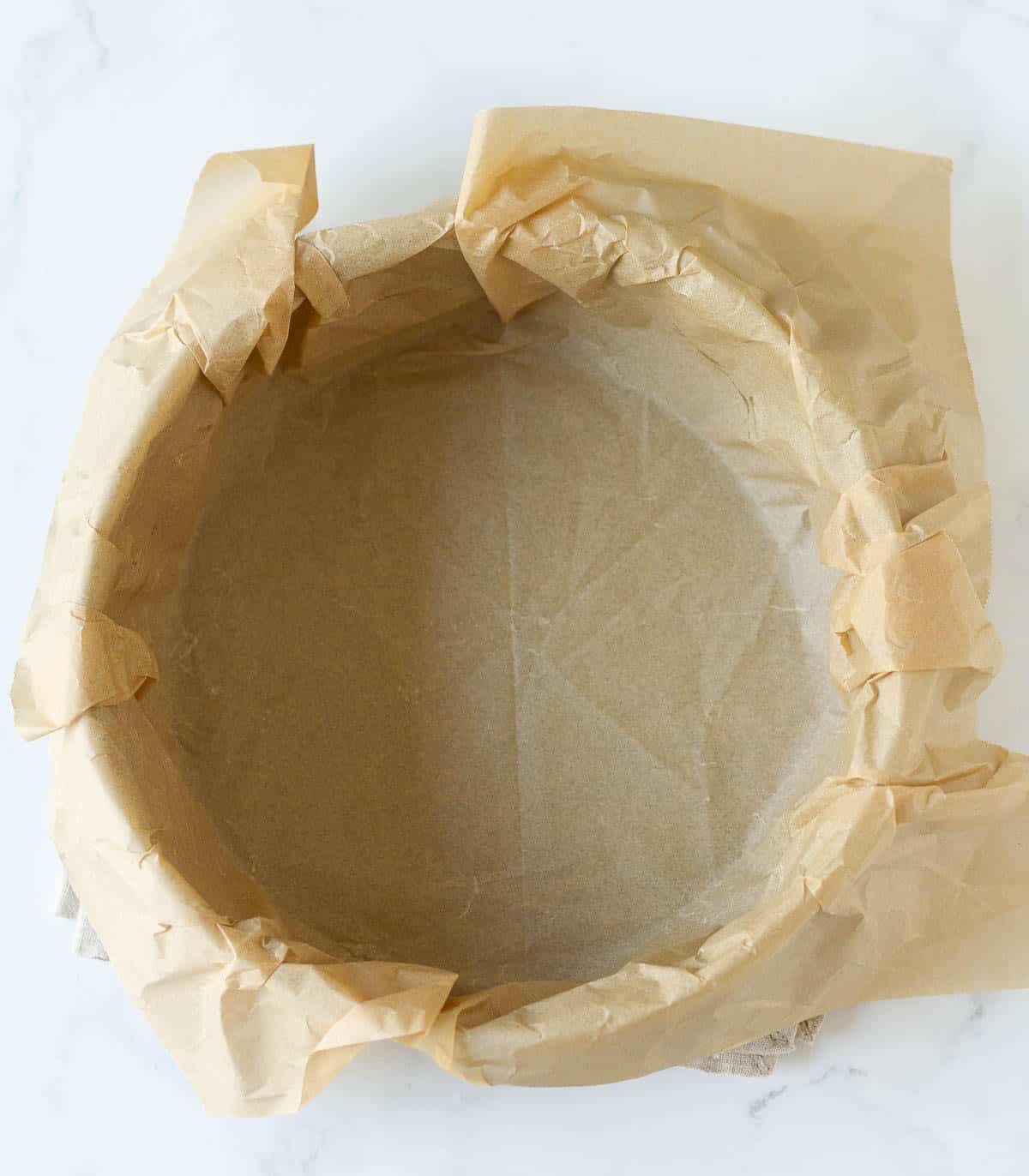 Cake pan lined with parchment paper.