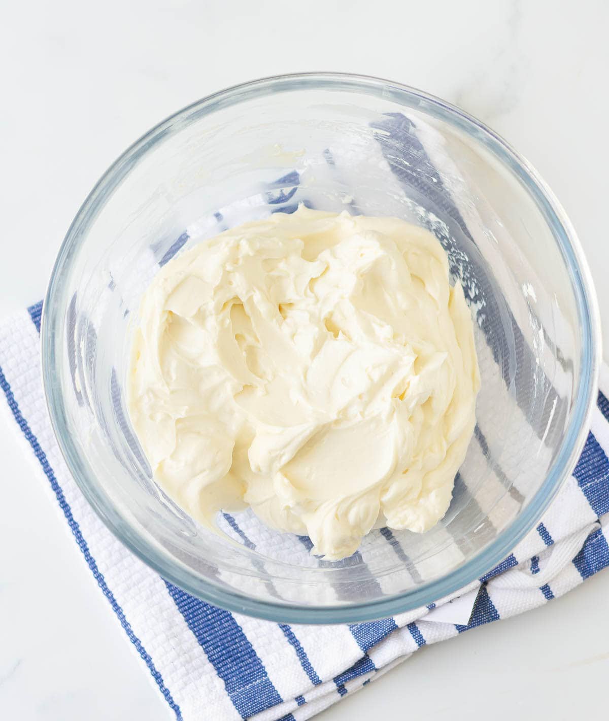 Cream cheese and sour cream in a mixing bowl.