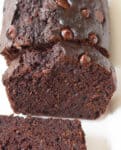 Sliced chocolate cake on a white platter.