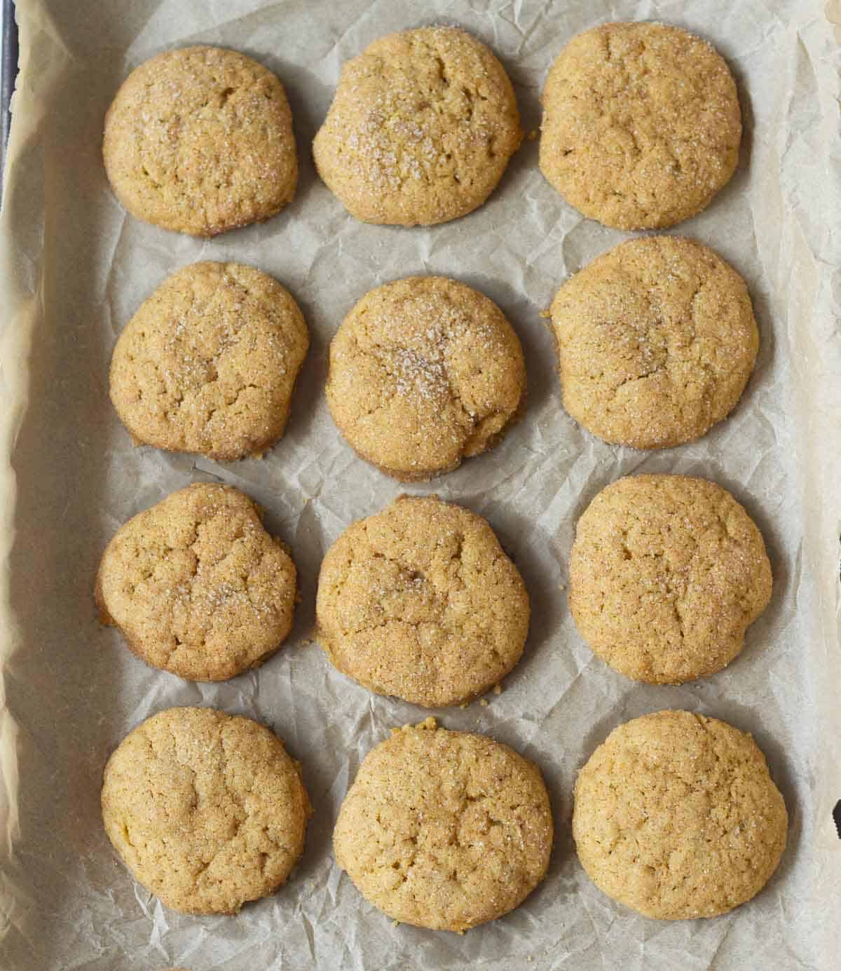Baked cookies on a parchment-lined tray.