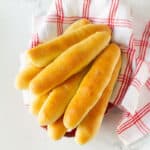 breadsticks on a red and white napkin.