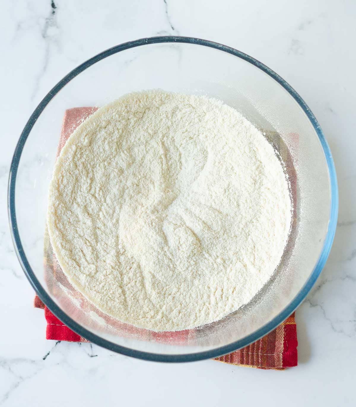 Dry ingredients for making cake in a mixing bowl.