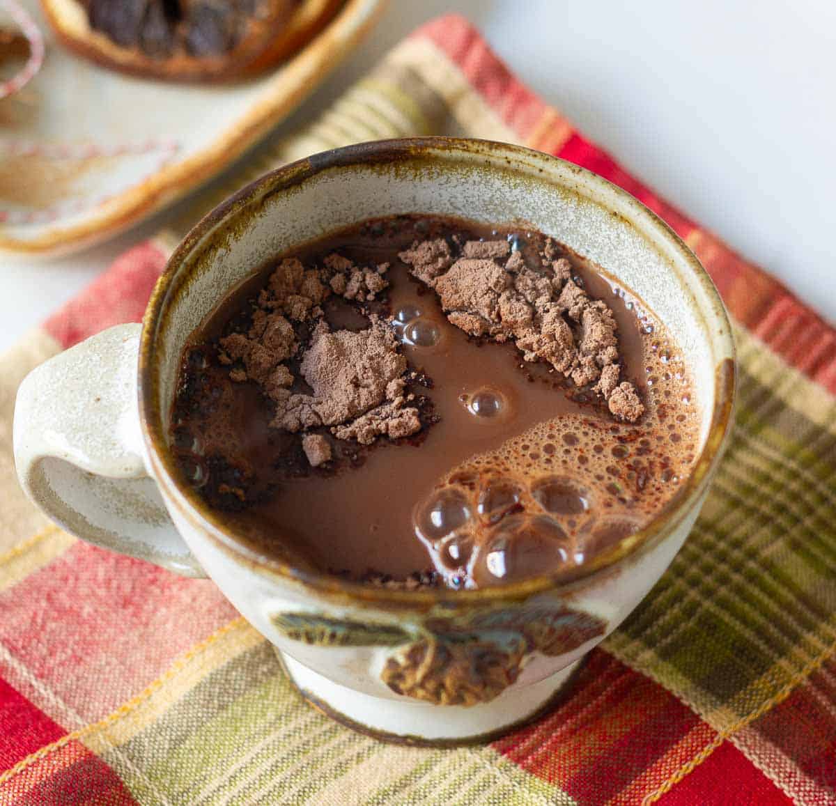 Hot water on top of cocoa mix in a cup.