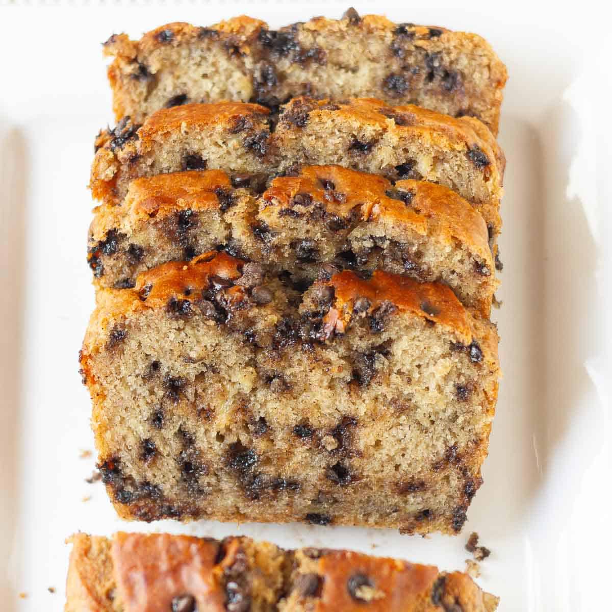 sliced chocolate chip banana bread on a platter.