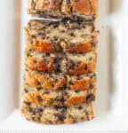 Sliced cake with chocolate chips on a rectangular white platter.