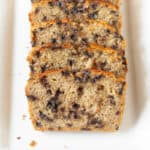 Slices of chocolate chip cake on a white platter.