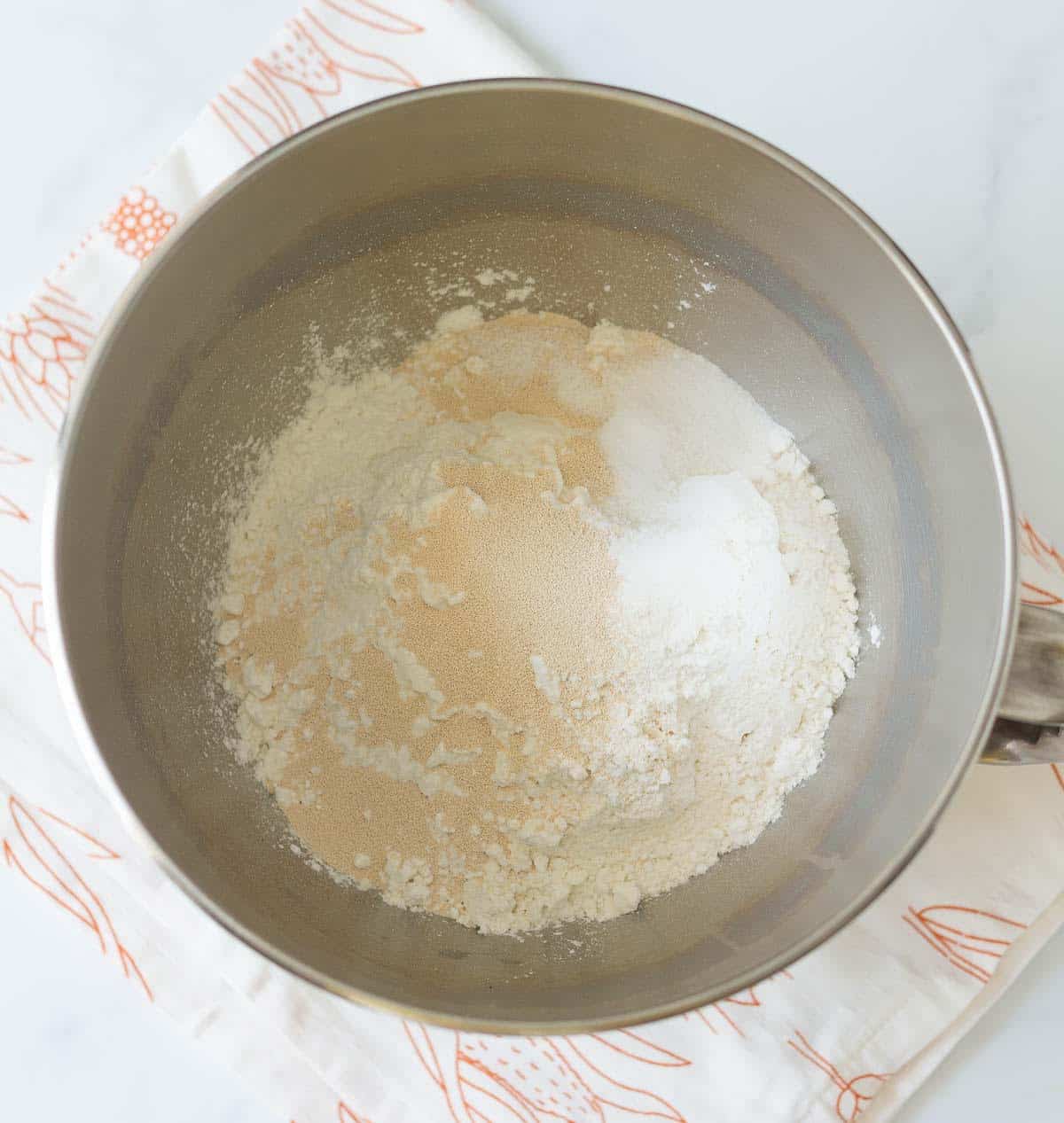 Flour, yeast, and salt in a stand mixer bowl.