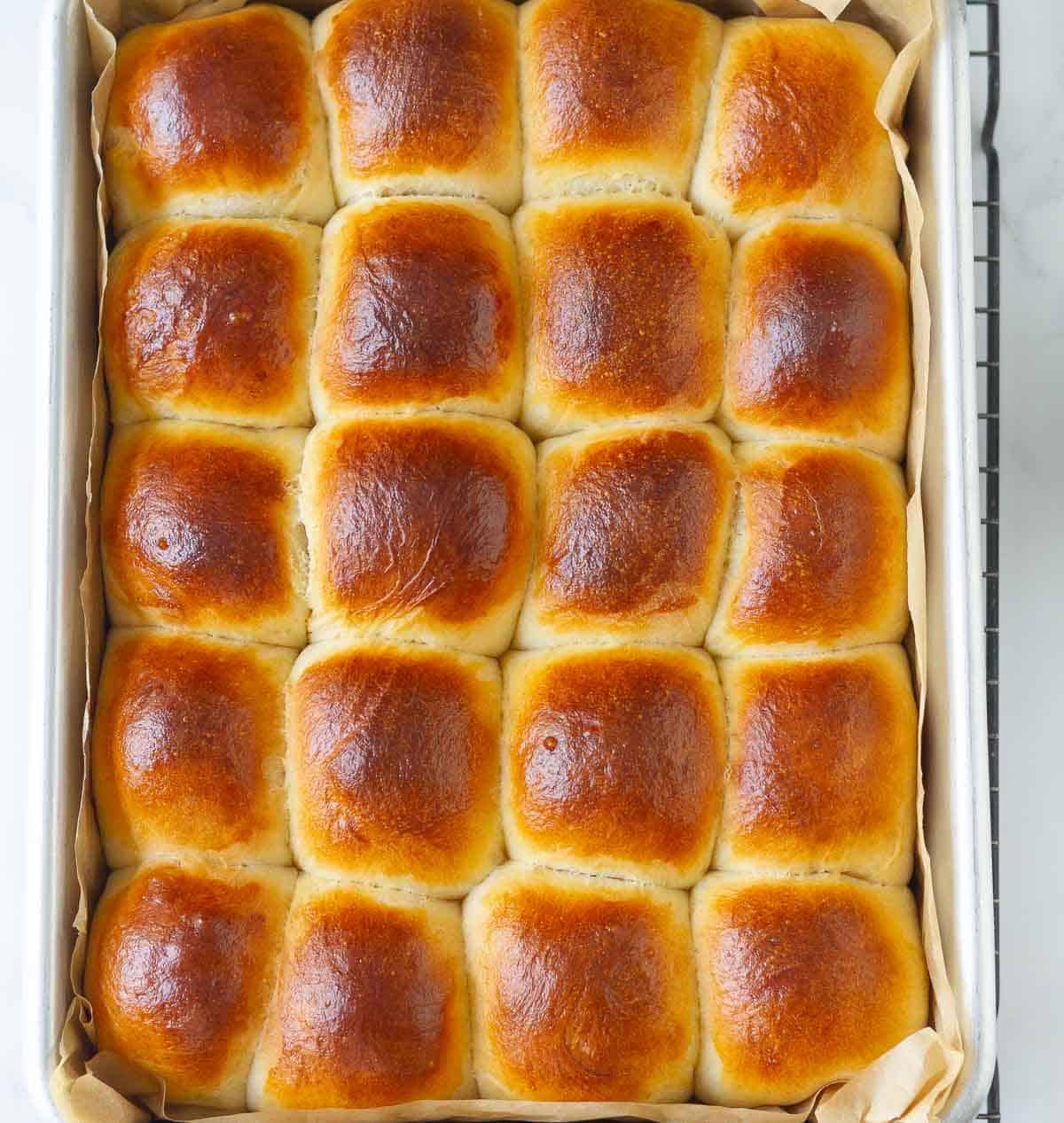 Baked Hawaiian dinner rolls in a baking dish.