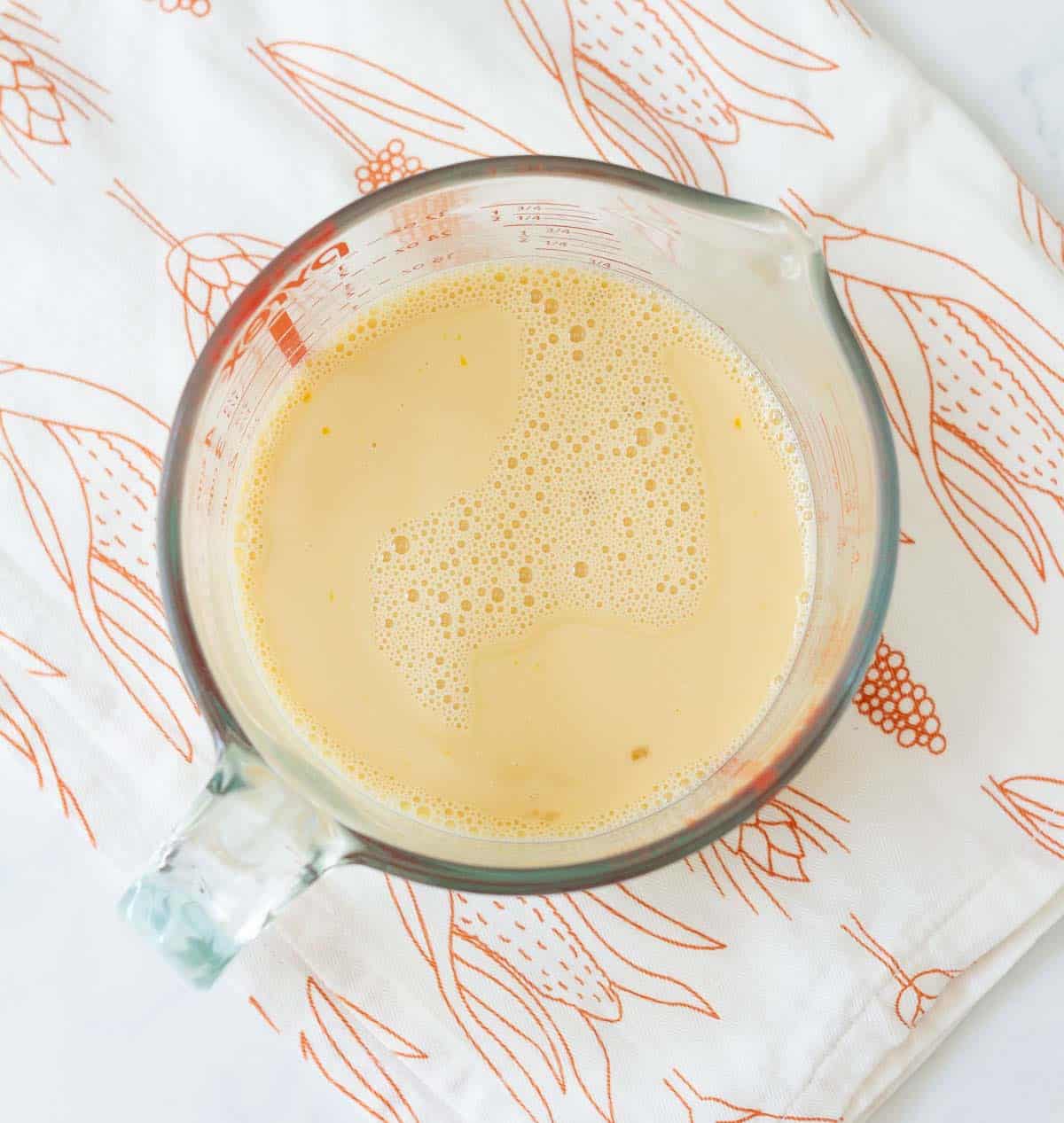 A mixture of liquid ingredients in a glass measuring cup.