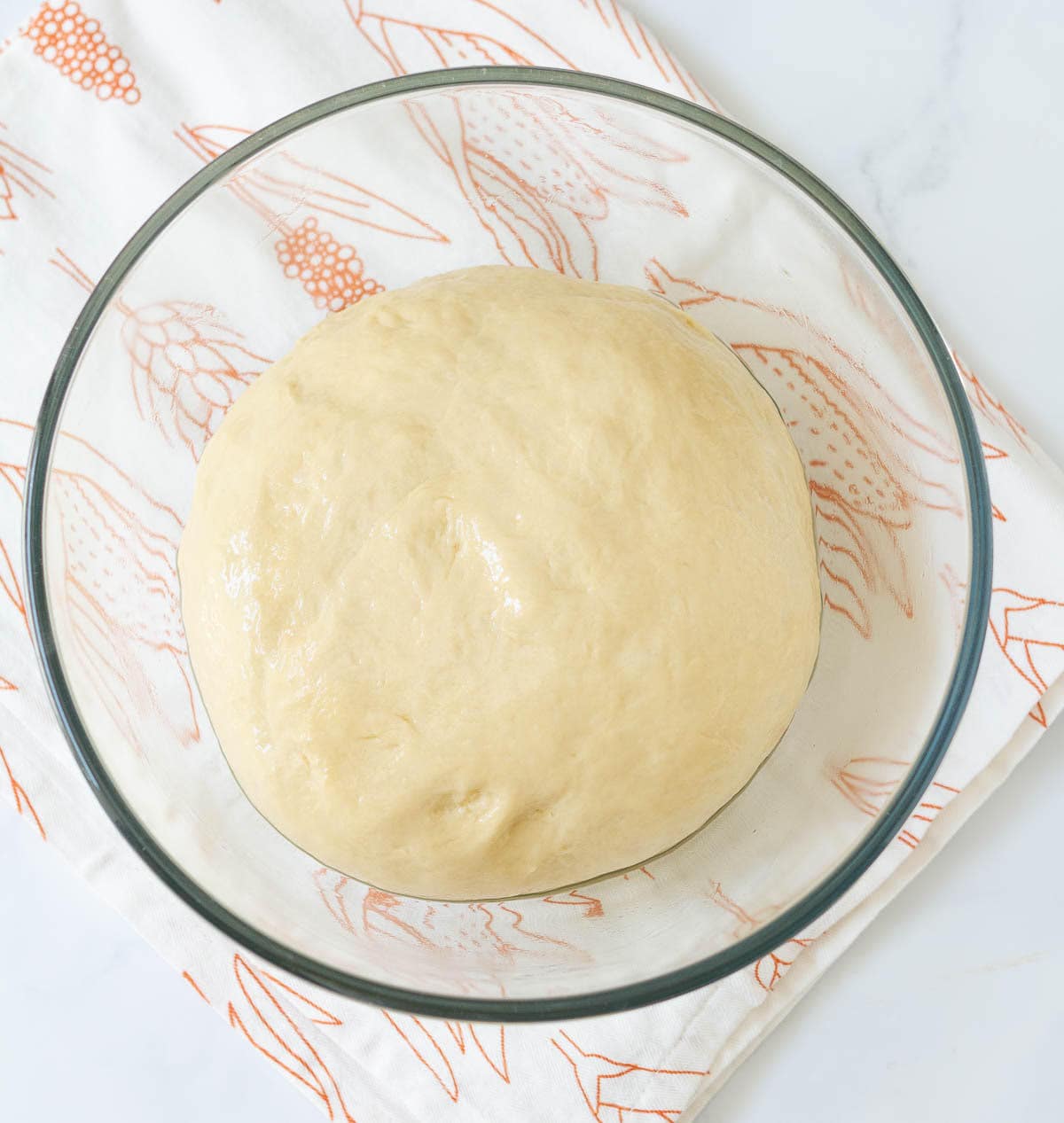 Dough in a glass bowl.